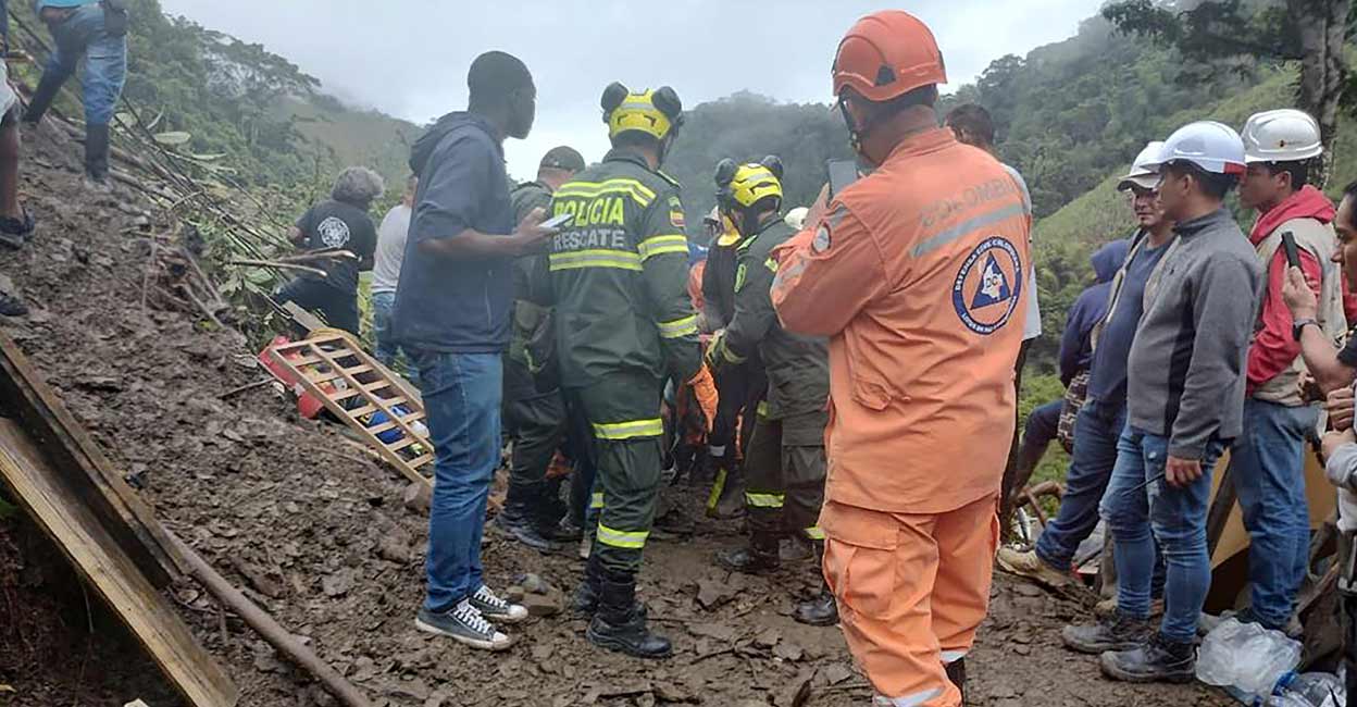 Police help the rescue operations of a bus that was buried after a landslide due to heavy rains in Pueblo Rico, Colombia: Colombia National Police/Handout via REUTERS