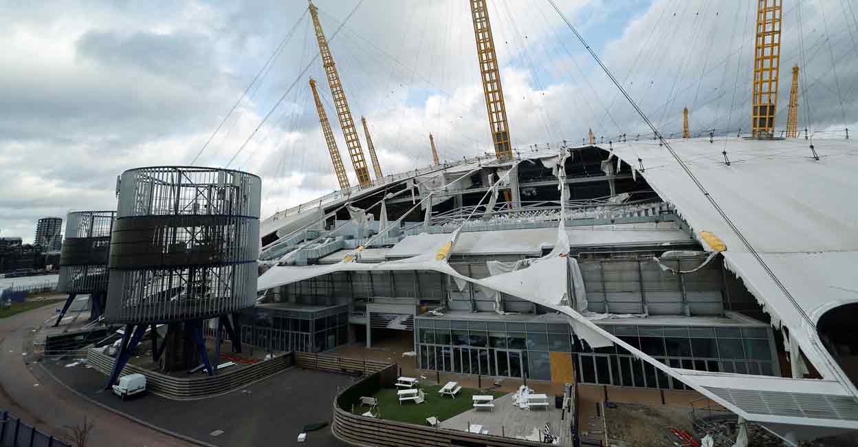 BRITAIN-WEATHER-STORM Wind-damaged sections of the roof of The O2 Arena, formerly the Millennium Dome, are pictured in London on Friday as Storm Eunice batters the country. Photo: AFP