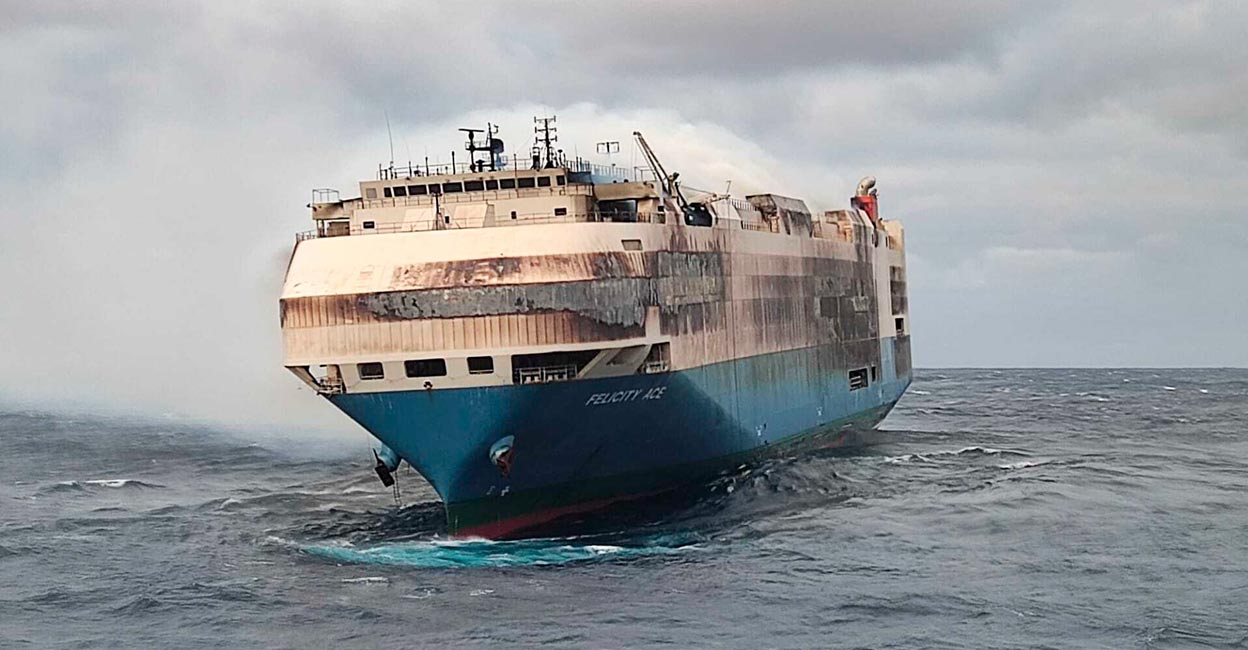 Smoke billows from the burning Felicity Ace car transport ship as seen from the Portuguese Navy NPR Setubal ship southeast of the mid-Atlantic Portuguese Azores Islands. The ship's crew were taken by helicopter to Faial island on the archipelago, about 170 kilometers (100 miles) away on Wednesday, Feb. 16, 2022. Photo: Portuguese Navy