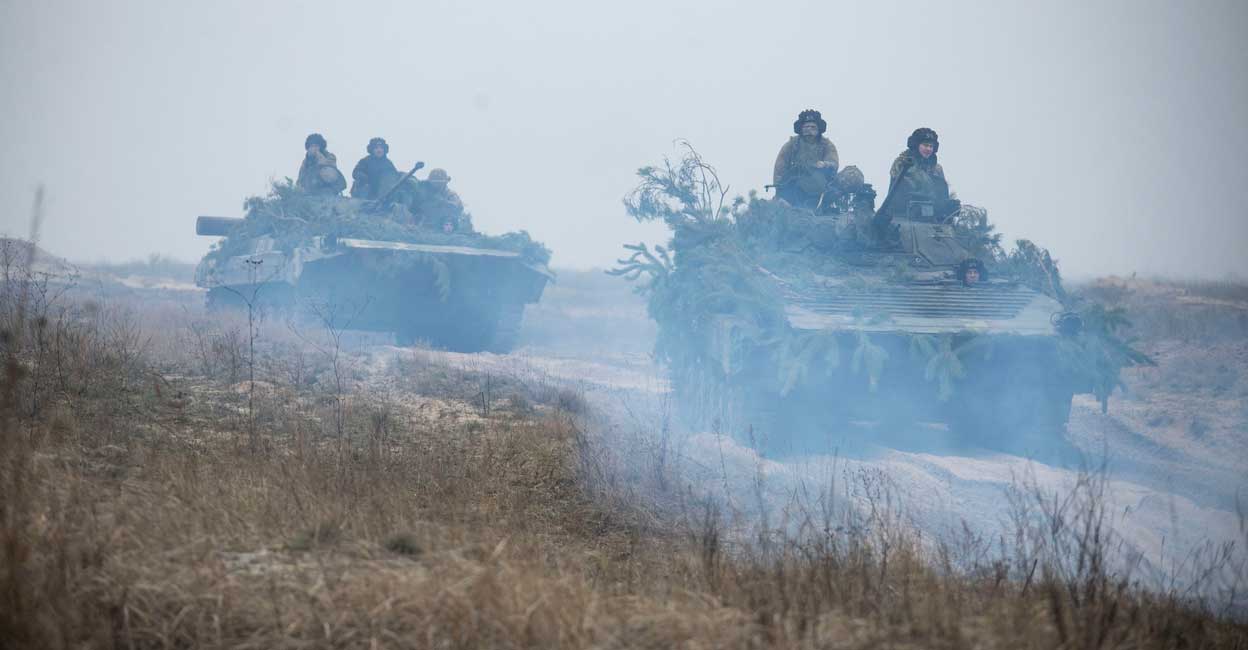 Ukrainian service members Ukrainian service members ride atop armoured fighting vehicles during tactical drills at a training ground in an unknown location in Ukraine, in this handout picture released February 22, 2022. Photo: Press service of the Ukrainian Armed Forces General Staff/Reuters