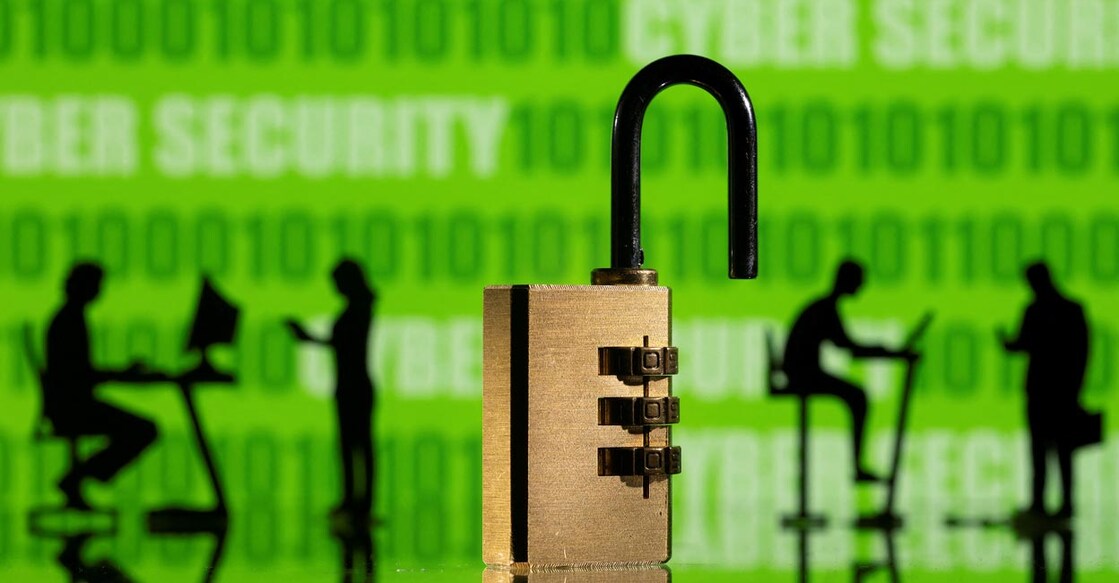 3D printed models of people working on computers and padlock are seen in front of a displayed CYBER SECURITY words and binary code in this picture illustration taken, February 1, 2022. Illustration: REUTERS/Dado Ruvic