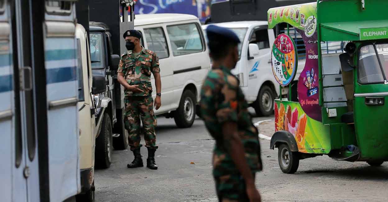 SRI-LANKA-CRISIS-QUEUES FILE PHOTO: Sri Lanka's Army members stand guard at a Ceylon Petroleum Corporation fuel station to help stations distribute oil during the fuel crisis, in Colombo, Sri Lanka March 22, 2022. REUTERS/Dinuka Liyanawatte/File Photo
