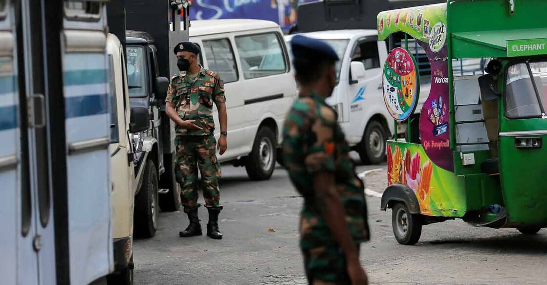 SRI-LANKA-CRISIS-QUEUES FILE PHOTO: Sri Lanka's Army members stand guard at a Ceylon Petroleum Corporation fuel station to help stations distribute oil during the fuel crisis, in Colombo, Sri Lanka March 22, 2022. REUTERS/Dinuka Liyanawatte/File Photo