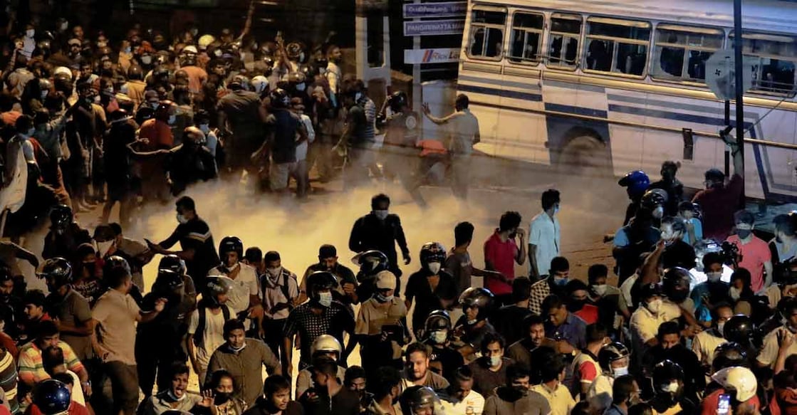 Demonstrators move away from tear gas used by the police near Sri Lankan President Gotabaya Rajapaksa's residence during a protest against him as many parts of the crisis-hit country faced up to 13 hours without electricity due to a shortage of foreign currency to import fuel, in Colombo, Sri Lanka March 31, 2022. REUTERS/Dinuka Liyanawatte
