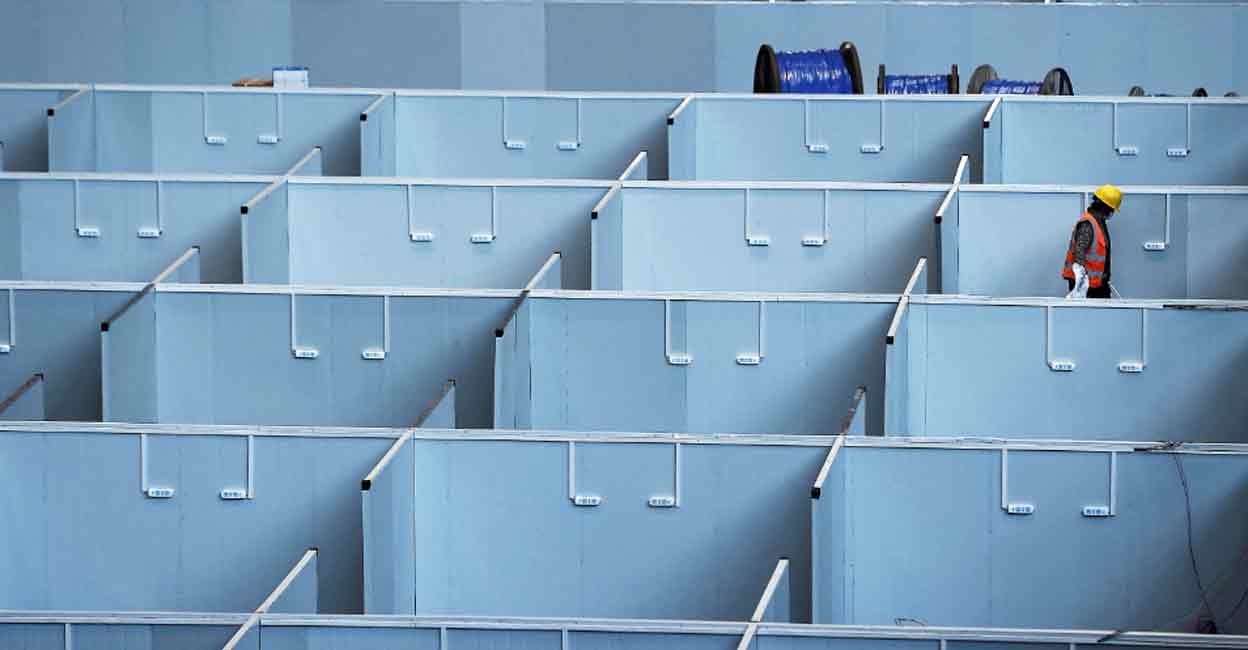 covid China A worker labours to convert the National Exhibition and Convention Center into a makeshift hospital for the coronavirus disease (COVID-19), in Shanghai, China last week. File photo: Reuters
