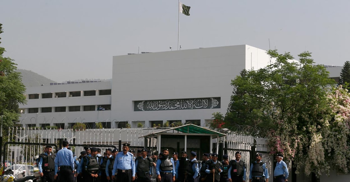 Police officers stand guard to ensure security outside the National Assembly, in Islamabad, Pakistan, Saturday, April 9, 2022. Pakistan's embattled prime minister faces a tough no-confidence vote Saturday waged by his political opposition, which says it has the numbers to defeat him. (AP Photo/Anjum Naveed)