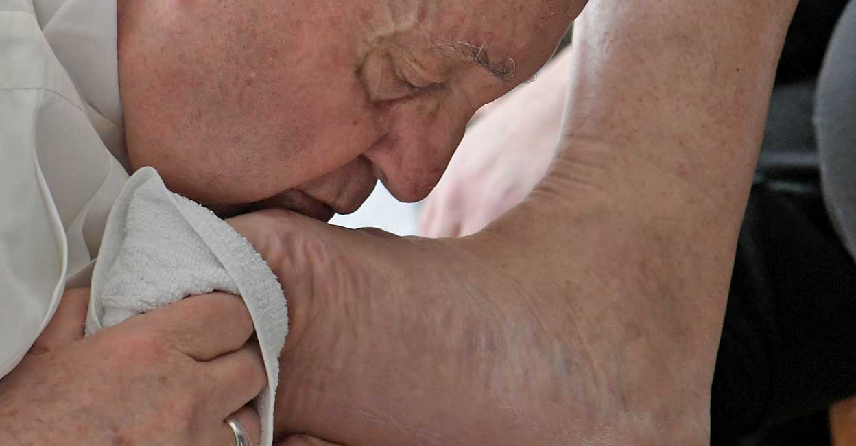 Pope visits Italian prison for traditional foot washing Mass Pope Francis kisses the feet of inmates at the Civitavecchia prison in Civitavecchia, Italy, April 14, 2022. Vatican Media/Handout via Reuters