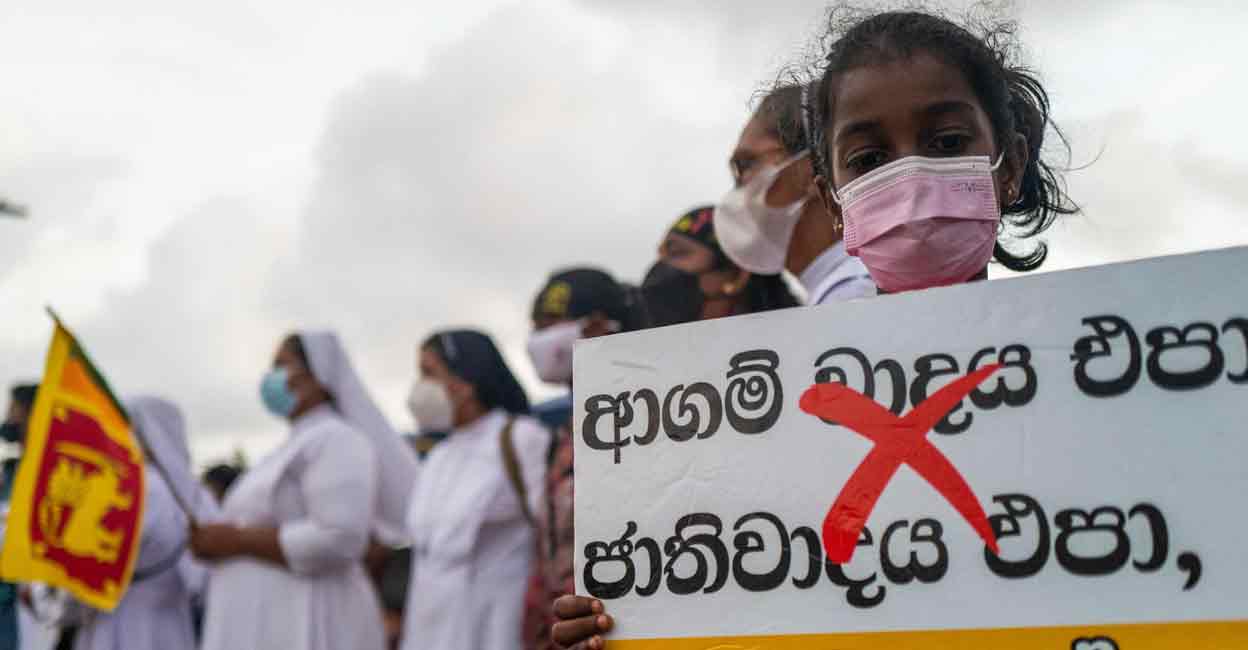 SRI LANKA-POLITICS-ECONOMY-PROTEST A child protester displays a placard during an ongoing anti-government demonstration near the president's office in Colombo on Tuesday demanding President Gotabaya Rajapaksa's resignation. Photo: AFP