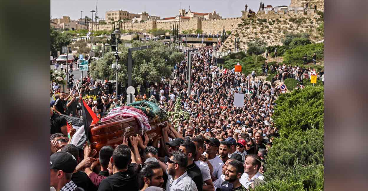 Palestinian mourners carry the casket of slain Al-Jazeera journalist Shireen Abu Aklel from a church toward the cemetary, during her funeral procession in Jerusalem on Friday. Photo: AFP/ Ronaldo Schemidt