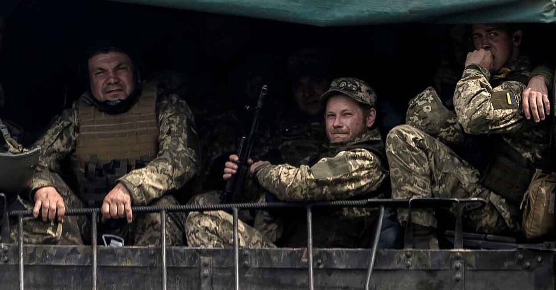 As Russia intensifies push for Donbas, Ukraine rules out ceasefire Service members of the Ukrainian armed forces travel on a military vehicle, amid Russia's invasion, near the town of Bakhmut, in the Donetsk region, Ukraine, May 21, 2022. Phato: Carlos Barria/Reuters