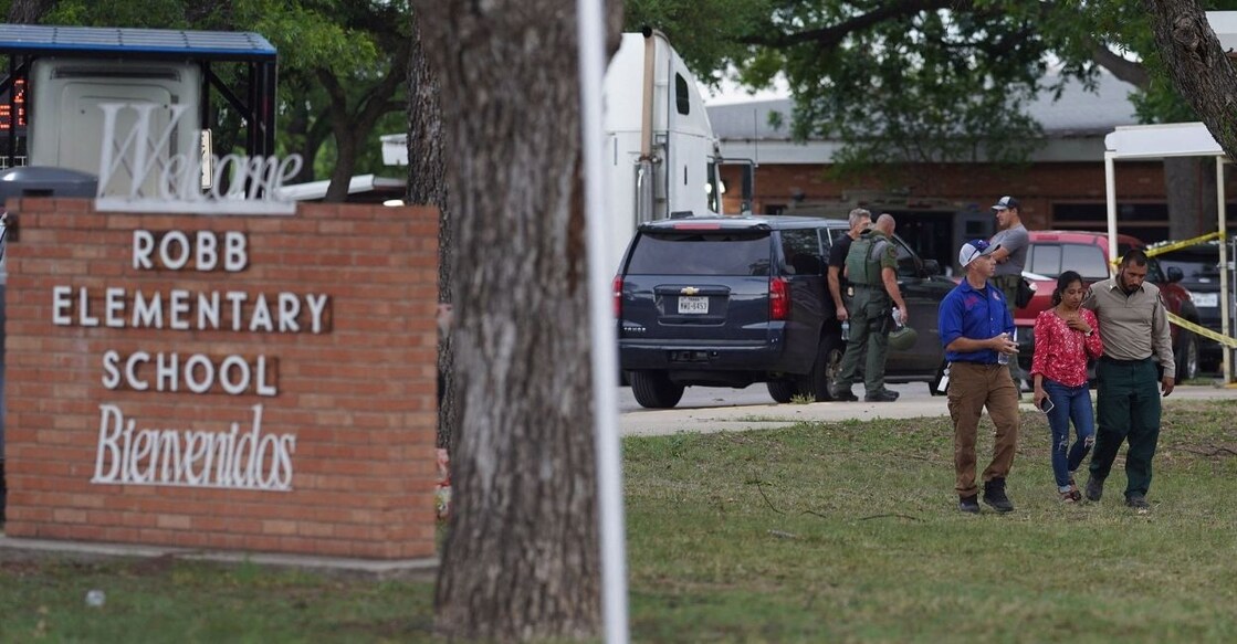 A welcome sign is seen outside of Robb Elementary School as people walk away in Uvalde, Texas, on May 24, 2022. PHOTO: AFP