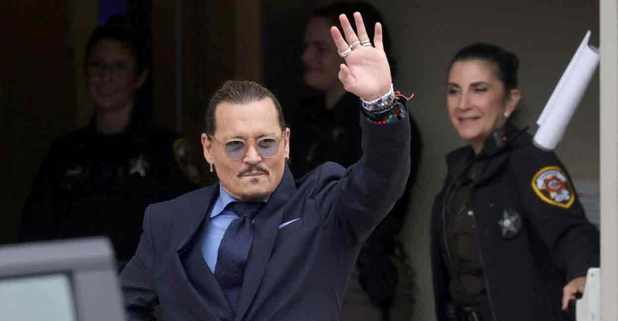 Actor Johnny Depp gestures as he leaves the Fairfax County Circuit Courthouse following his defamation trial against his ex-wife Amber Heard, in Fairfax, Virginia, U.S., May 27, 2022. REUTERS/Evelyn Hockstein