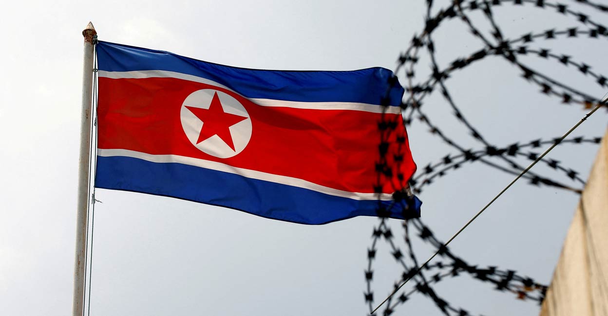 NORTHKOREA-MISSILES A North Korea flag flutters next to concertina wire at the North Korean embassy in Kuala Lumpur, Malaysia March 9, 2017. FILE PHOTO: Reuters/Edgar Su