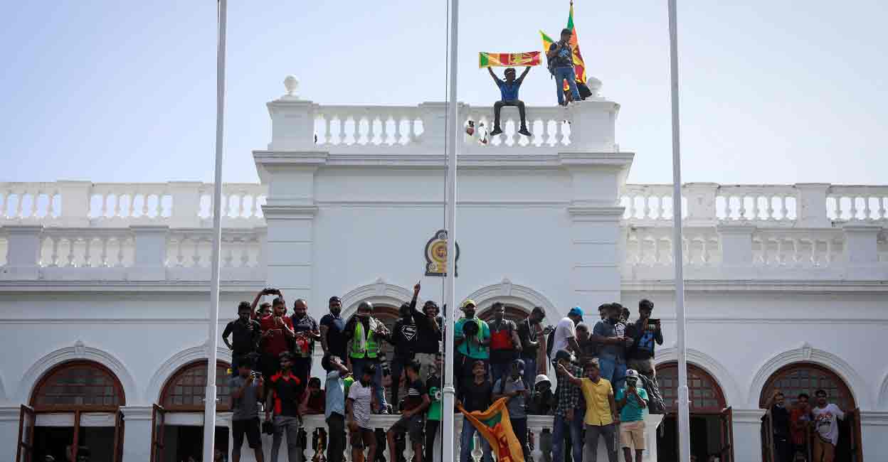 SRI-LANKA-CRISIS Protestors celebrate after entering the building of Sri Lanka's Prime Minister Ranil Wickremesinghe's office, amid the country's economic crisis, in Colombo, Sri Lanka July 13, 2022. REUTERS/Adnan Abidi