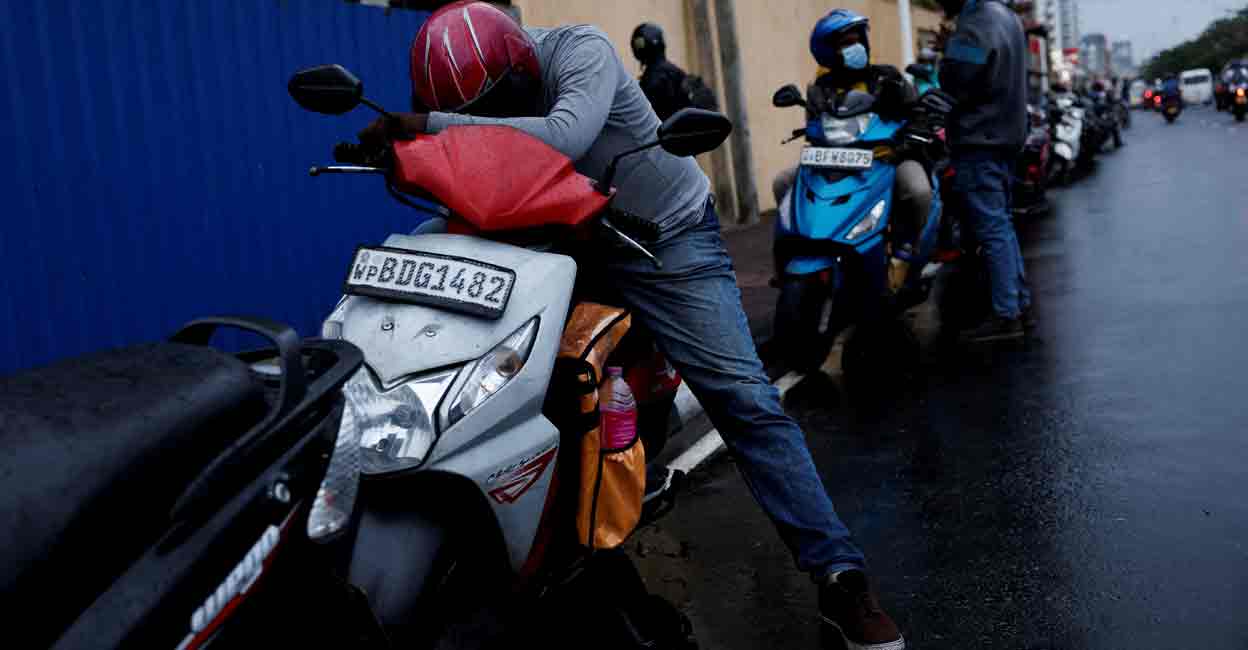 SRI-LANKA-CRISIS A man waits in a queue to buy petrol due to fuel shortage, amid the country's economic crisis, in Colombo, Sri Lanka, June 16, 2022. REUTERS/Dinuka Liyanawatte/File Photo