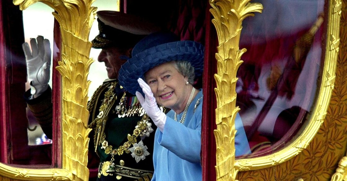 Britain's Queen Elizabeth II waves to the crowd as she rides 04 June 2002 in the Gold State coach from Buckingham Palace to St Paul's Cathedral for a service of Thanksgiving to celebrate her Golden Jubilee. File Photo: AFP