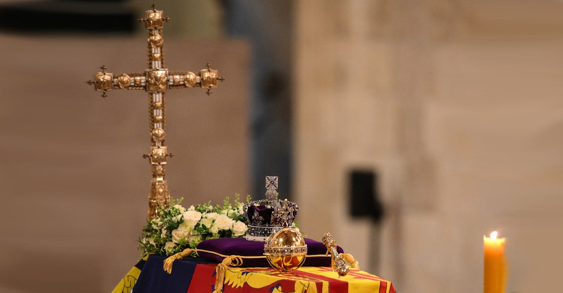 The coffin of Queen Elizabeth II, draped in the Royal Standard with the Imperial State Crown and the Sovereign's orb and sceptre, lying in state on the catafalque in Westminster Hall, at the Palace of Westminster in London on September 16, 2022, is pictured during a royal vigil, ahead of her funeral on Monday. DANIEL LEAL/Pool via REUTERS