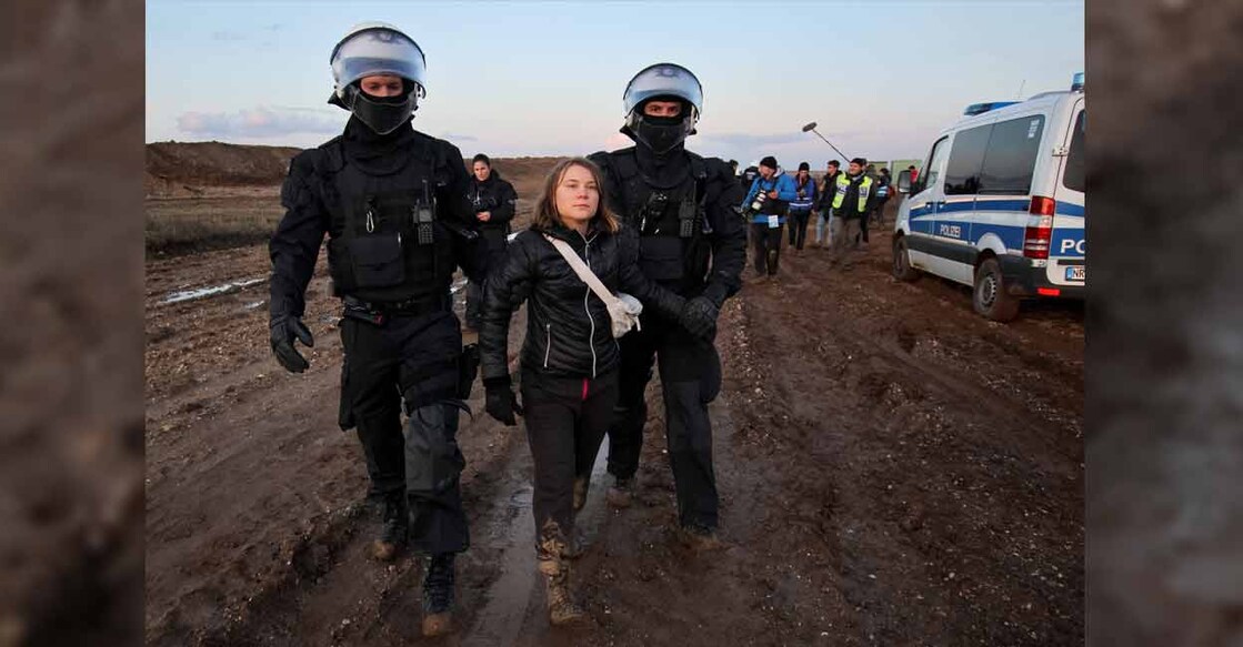 Police officers detain climate activist Greta Thunberg on the day of a protest against the expansion of the Garzweiler open-cast lignite mine of Germany's utility RWE to Luetzerath in Germany on Tuesday. Photo: Reuters/Wolfgang Rattay