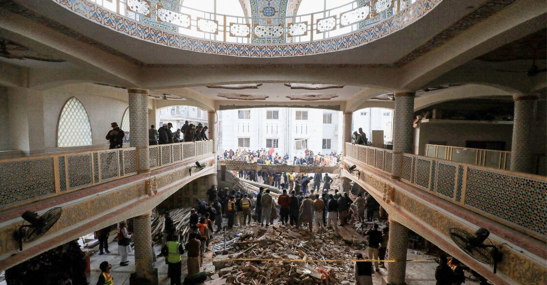 People and rescue workers gather to look for survivors under a collapsed roof, after a suicide blast in a mosque in Peshawar, Pakistan January 30, 2023. Photo: Reuters