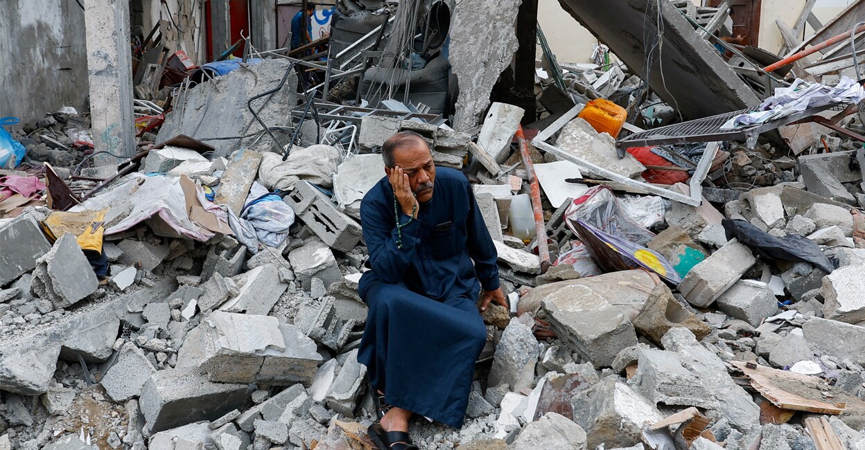hamas-israel-attack-add-2 A Palestinian sits on the rubble of a building destroyed in Israeli strikes, in Rafah in the southern Gaza Strip on Monday. Photo: REUTERS/Ibraheem Abu Mustafa