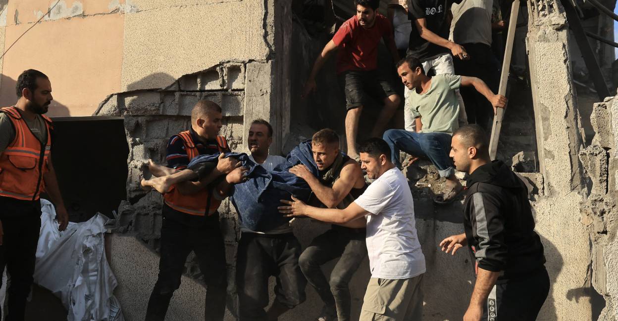 palestinians-hit-by-war Palestinians remove a body from the rubble of a building after an Israeli strike in Khan Yunis in the southern Gaza Strip. Photo: AFP