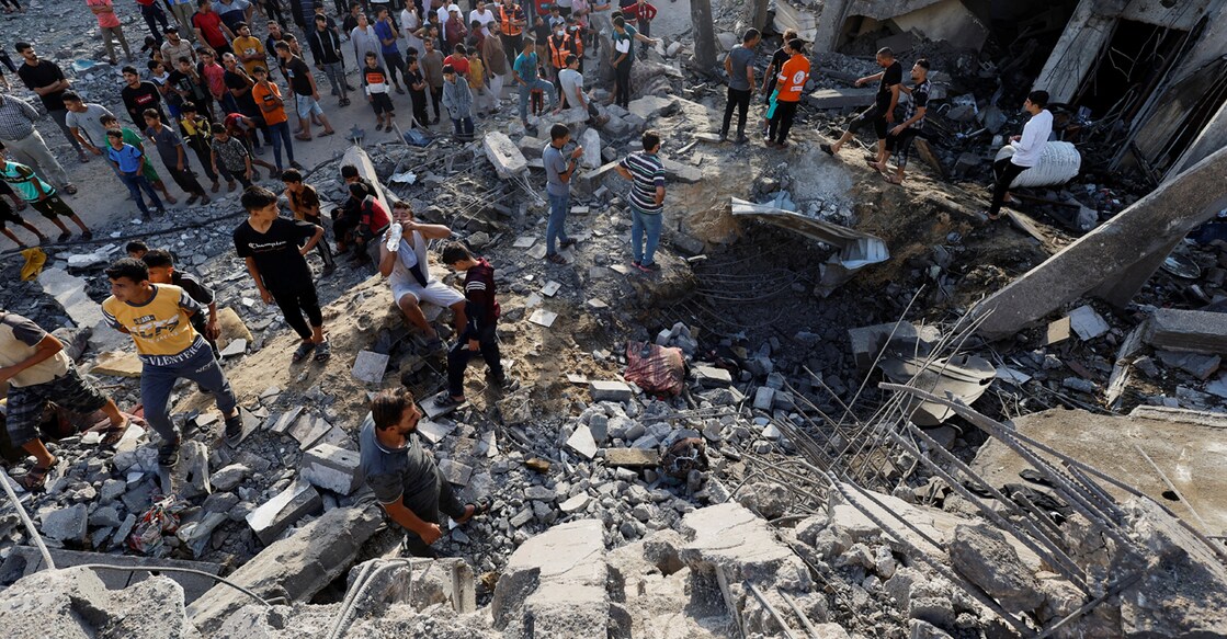 Palestinians search for casualties under the rubble of a building destroyed by Israeli strikes in Khan Younis in the southern Gaza Strip on Tuesday. Photo:  REUTERS/Mohammed Salem