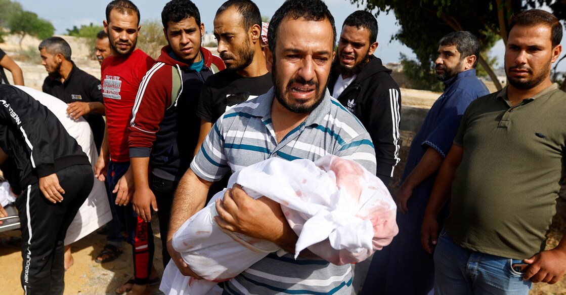 A mourner carries the body of a child, during the funeral of Palestinians who were killed in Israeli strikes, in Khan Younis in the southern Gaza Strip. Photo: Reuters