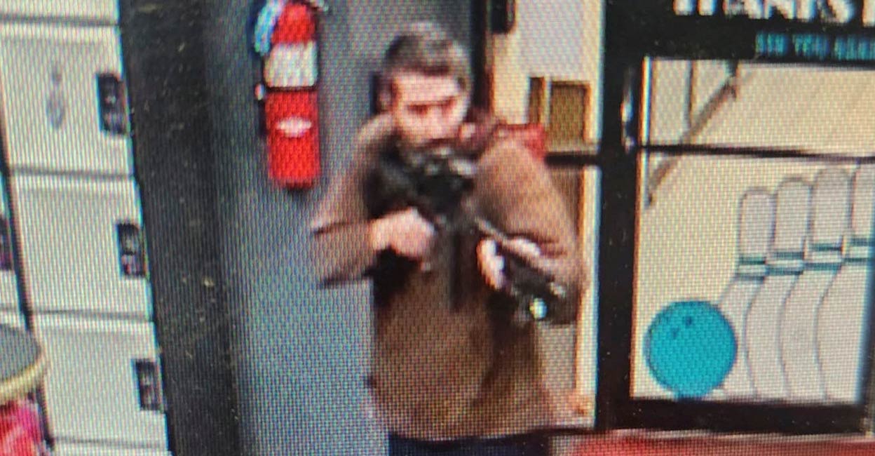 A man identified as a suspect by police points what appears to be a semiautomatic rifle, in Lewiston, Maine. Photo: Androscoggin County Sheriff’s Office via Facebook/Handout via REUTERS