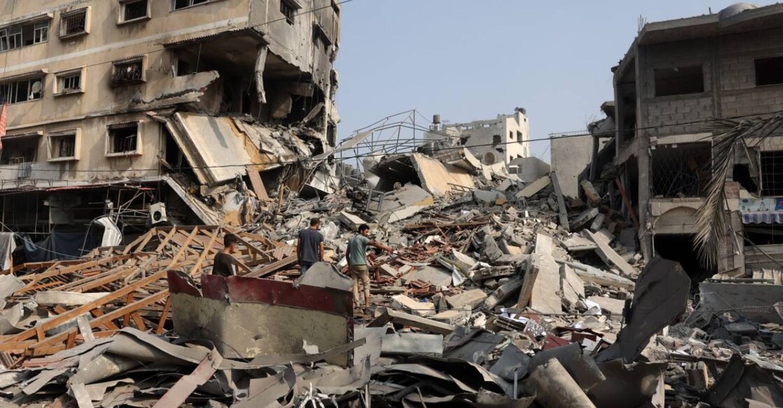 People sift through the rubble of a building destroyed in Israeli strikes on Gaza City . Photo: AFP