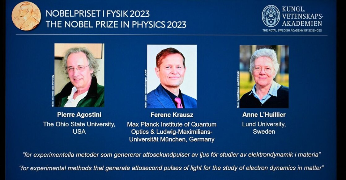 A tablet shows this year's laureates US-based physicist Pierre Agostini, Hungarian-Austrian physicist and French physicist Anne L’Huillier during the announcement of the winners of the 2023 Nobel Prize in Physics at Royal Swedish Academy of Sciences in Stockholm on October 3, 2023. Photo: Jonathan Nackstrand/AFP