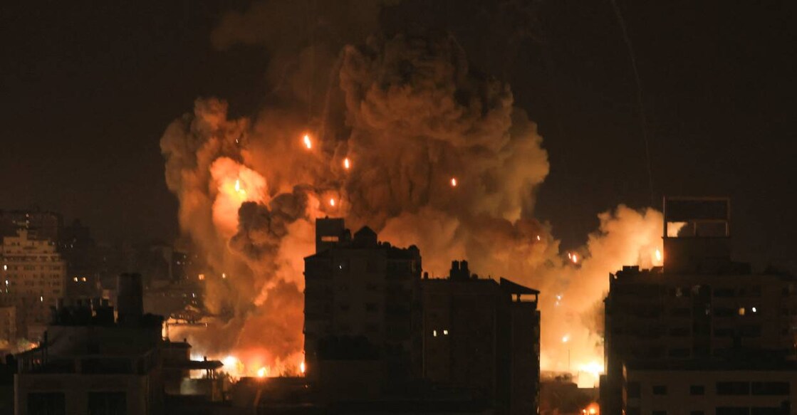 Fire and smoke rise above buildings in Gaza City during an Israeli air strike . Photo: AFP