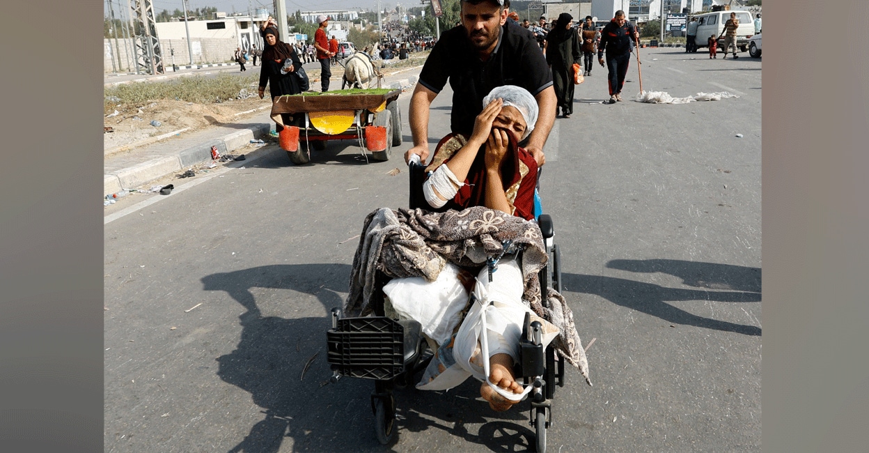 injured-palestinian-escape-gaza A Palestinian woman, who was injured in an Israeli strike and was staying at Al Shifa hospital, moves southward after fleeing north Gaza as Israeli tanks roll deeper into the enclave, amid the ongoing conflict between Israel and Hamas, in the central Gaza Strip November 10, 2023. Photo: Reuters/Ibraheem Abu Mustafa