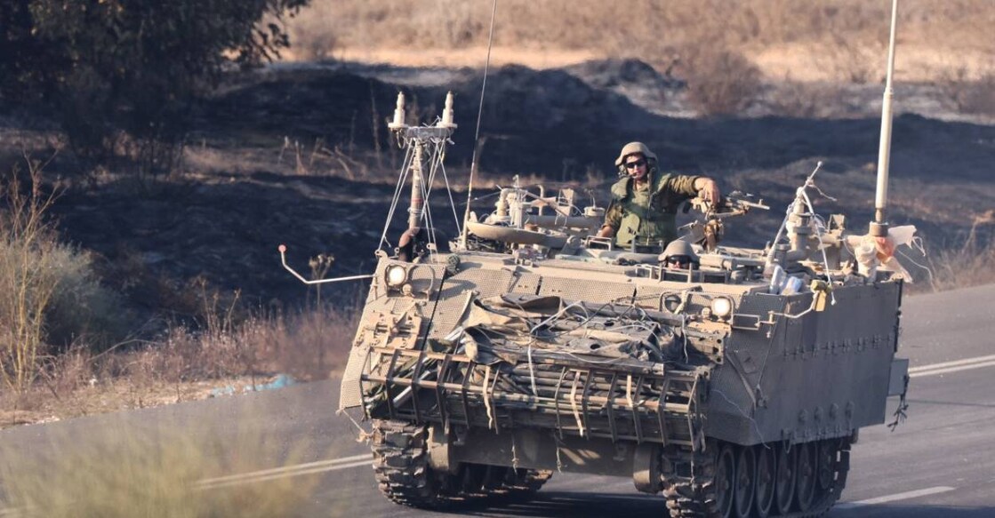 An Israeli vehicle moves with a military convoy along the border between Israel and the Gaza Strip. Photo: AFP