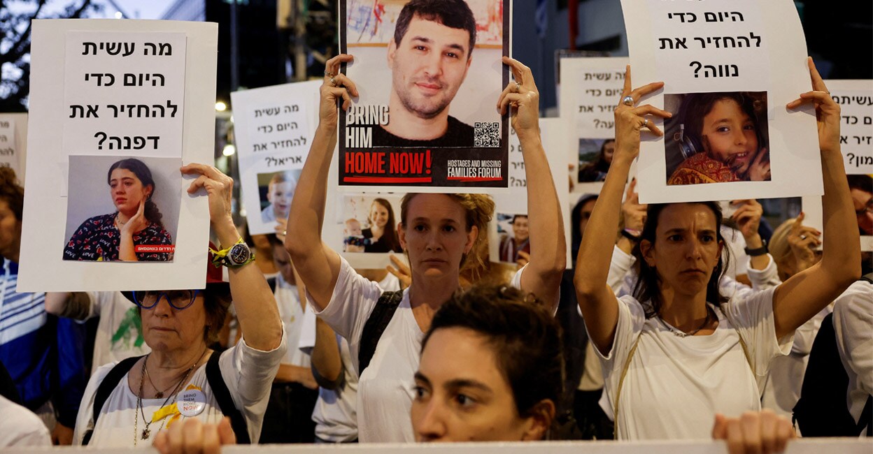 gaza-israeli-hostages-add1 Protesters hold signs demanding the liberation of hostages who are being held in the Gaza Strip. Photo: REUTERS/Amir Cohen