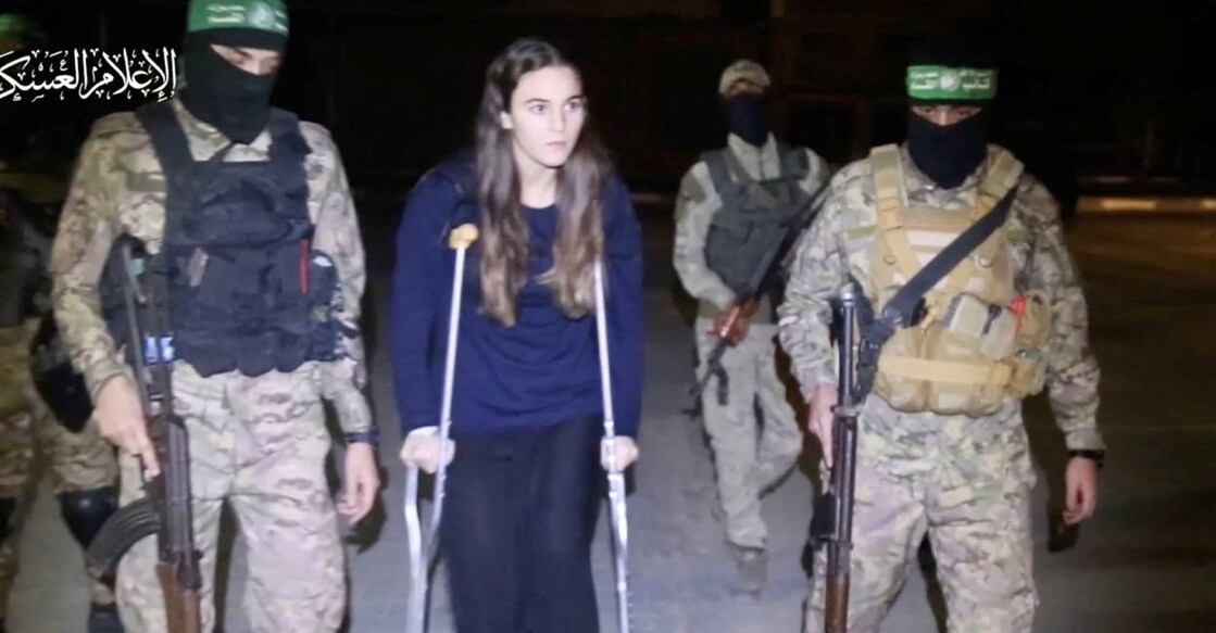 A hostage who was abducted by Hamas gunmen during the October 7 attack on Israel, is handed over by Hamas militants to members of the International Committee of the Red Cross. Photo: Reuters