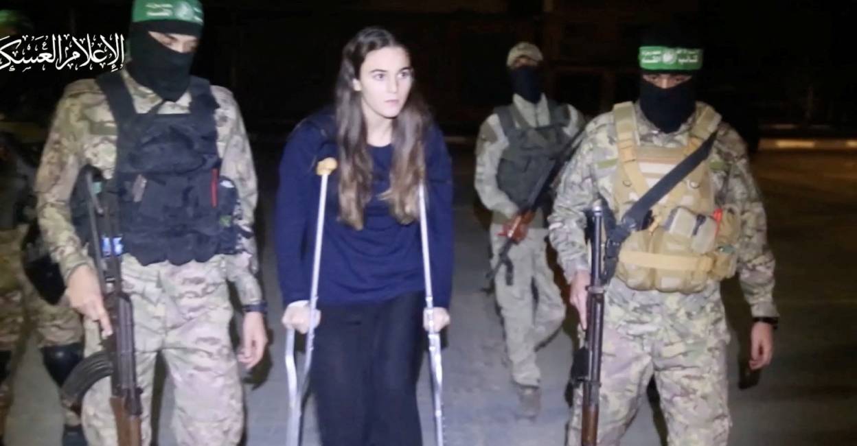 A hostage who was abducted by Hamas gunmen during the October 7 attack on Israel, is handed over by Hamas militants to members of the International Committee of the Red Cross. Photo: Reuters