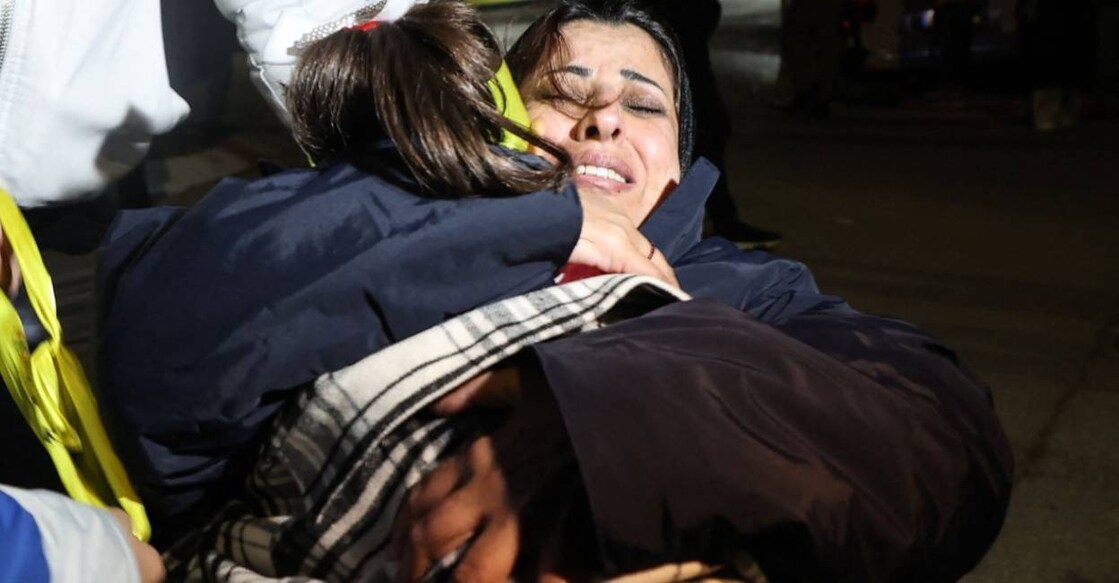 Newly released Palestinian prisoner Manal Dudeen hugs her daughter after disembarking a Red Cross bus. Photo: AFP