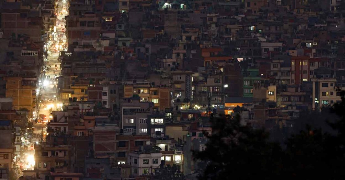 Light illuminates a street between the cluster of residential buildings in Kathmandu, Nepal November 8, 2022. File Photo: REUTERS/Navesh Chitrakar