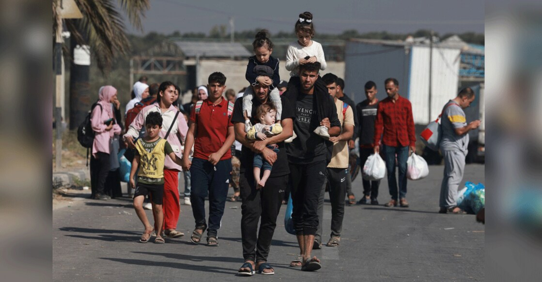 gaza-palestinians-flee-israel-attack Palestinians fleeing Gaza City and other parts of northern Gaza towards the southern areas, walk on a road on November 8, 2023 amid the ongoing battles between Israel and the Palestinian Islamist group Hamas. Photo: AFP/Mohammed Abed