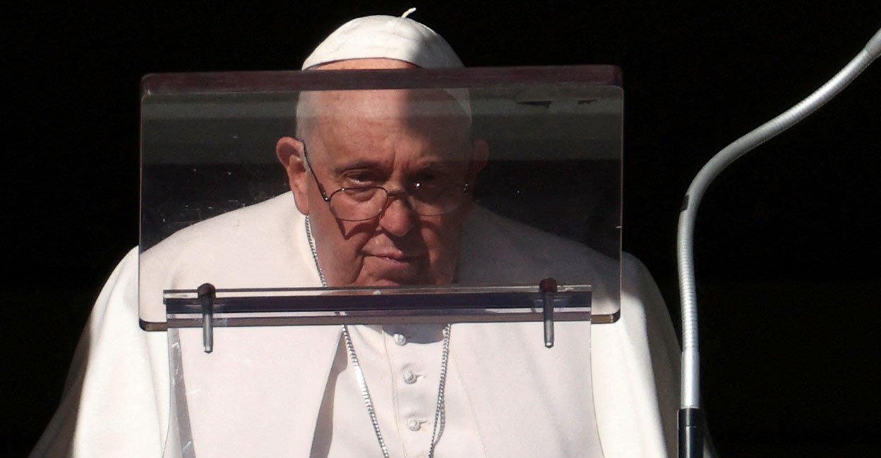 Pope Francis looks on to lead the Angelus prayer from his window at the Vatican on Sunday. Photo: Reuters/Guglielmo Mangiapane