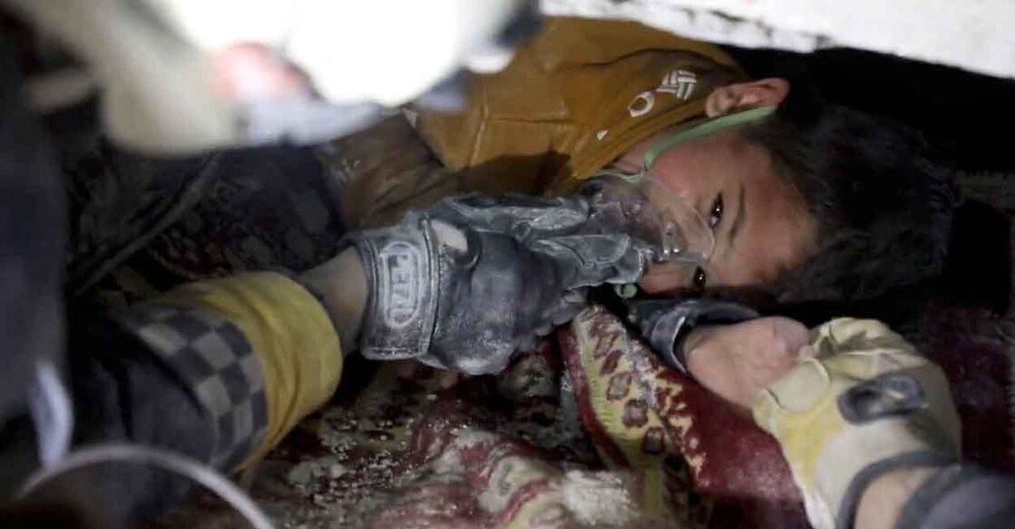 A child is rescued from the rubble in the aftermath of an earthquake in Azmarin, Syria, February 7, 2023 in this still image taken from video. Photo: White Helmets/Handout via Reuters