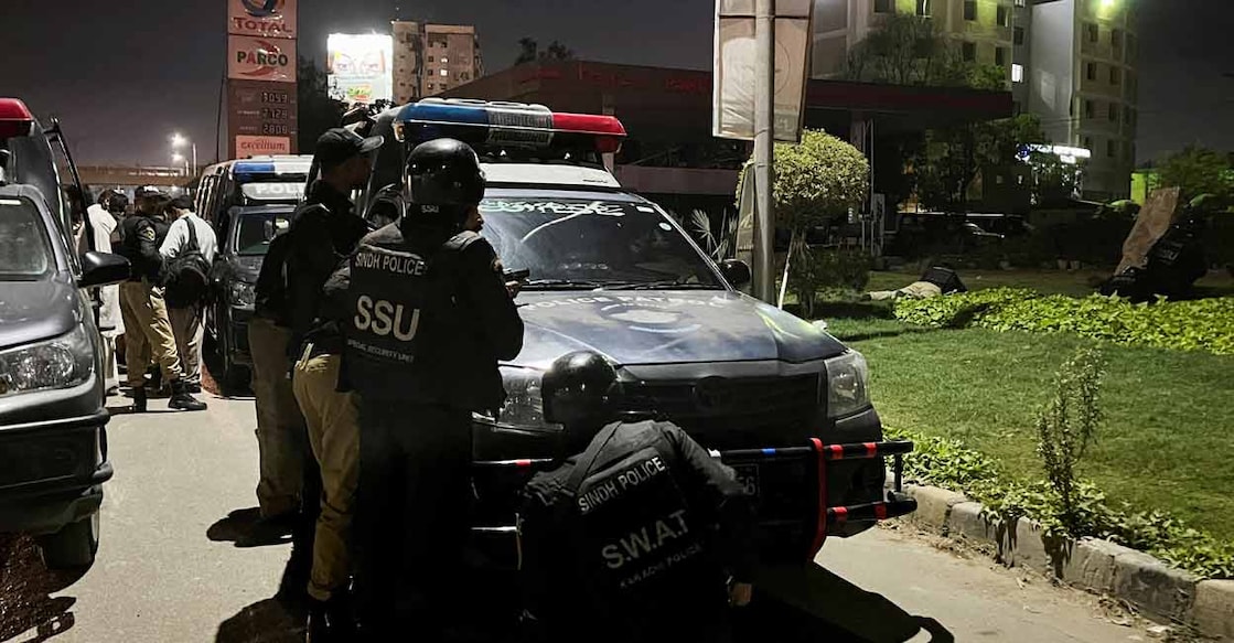 Police officers take position after a police office building was attacked by gunmen in Karachi, Pakistan on Friday. Photo: Reuters/Akhtar Soomro