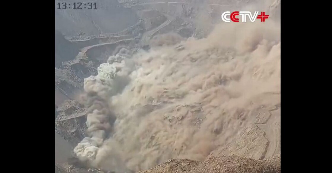 The open-pit mine operated by small local firm Xinjing Coal Mining Co collapsed in a landslide, leaving dozens of workers buried under a huge pile of debris half a kilometre wide and an estimated 80 m high. Pic Courtesy: Screengrab from CCTV (China's state broadcaster)