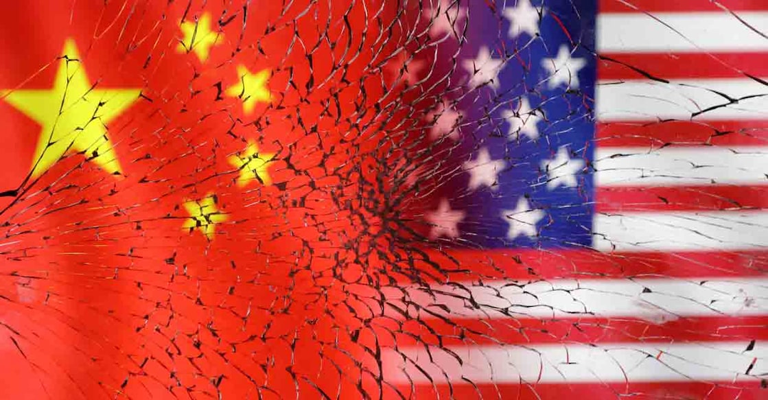 US and Chinese flags are seen through broken glass in this illustration taken, January 30, 2023. REUTERS/Dado Ruvic/Illustration