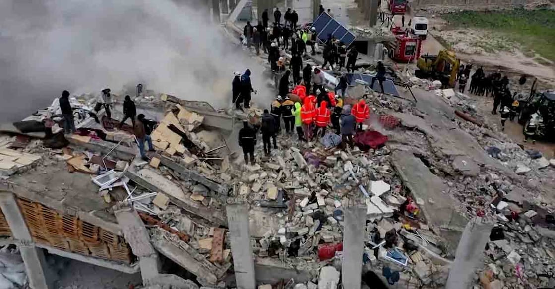 Rescuers search through rubble of collapsed buildings following an earthquake, in the rebel-held town of Sarmada, Syria February 6, 2023 in this still image obtained from a drone footage. WHITE HELMETS /Handout via REUTERS