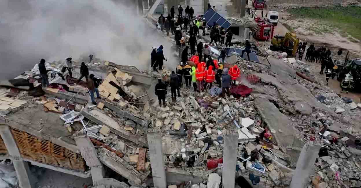 Rescuers search through rubble of collapsed buildings following an earthquake, in the rebel-held town of Sarmada, Syria February 6, 2023 in this still image obtained from a drone footage. WHITE HELMETS /Handout via REUTERS