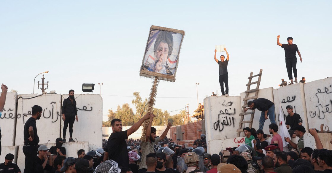 Protesters clash with security forces members as they gather near the Swedish embassy in Baghdad hours after the embassy was stormed and set on fire ahead of an expected Koran burning in Stockholm, in Baghdad. Photo: REUTERS/Ahmed Saad