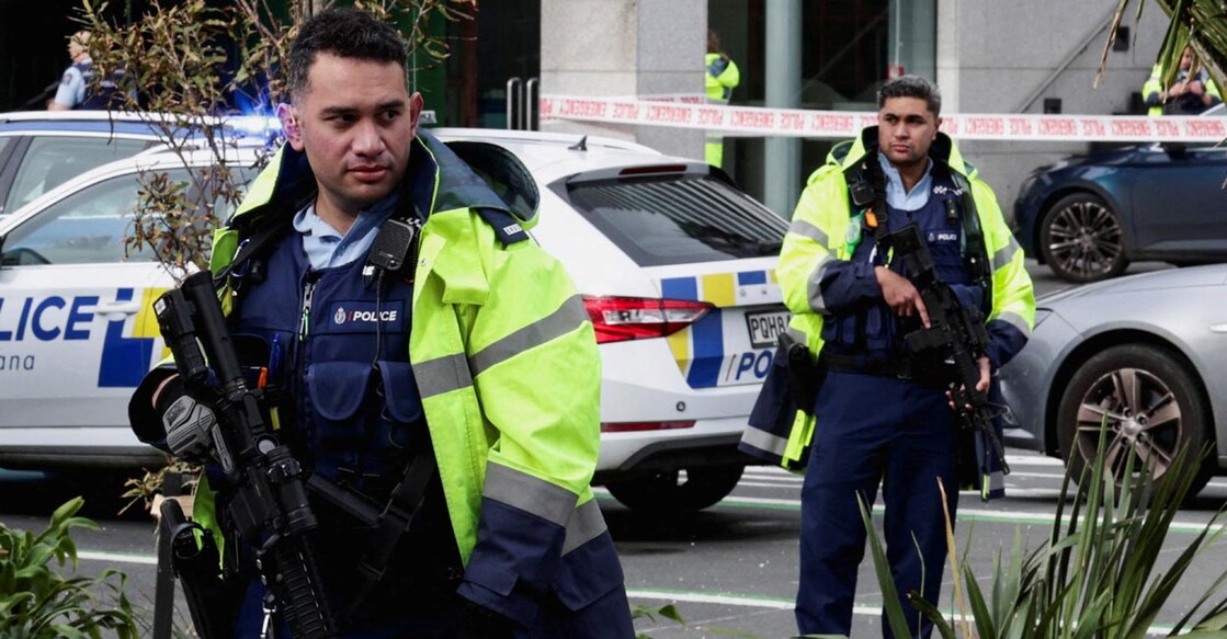 Armed police stand guard near a construction site following a shooting in Auckland. Photo: Reuters/David Rowland