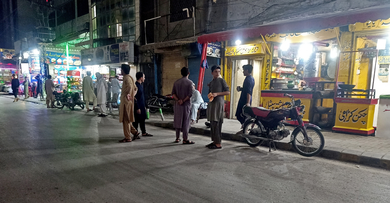 AFGHANISTAN-QUAKE/PAKISTAN People stand in the street after eateries were vacated following an earthquake in Peshawar, Pakistan on Saturday. Photo: Reuters