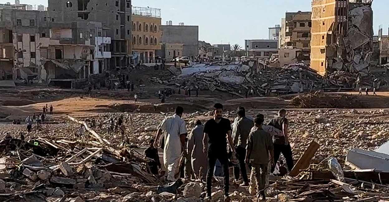 People walk through debris after a powerful storm and heavy rainfall hit Libya, in Derna, Libya. Photo: ALI M. BOMHADI/via REUTERS